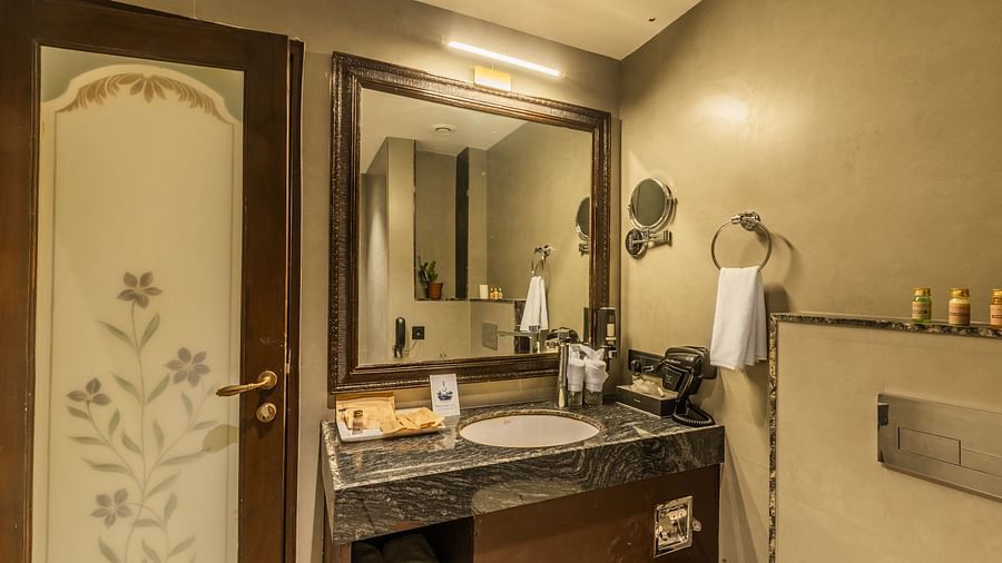 an image of a side view of a bathroom with toiletries and a cabinet.